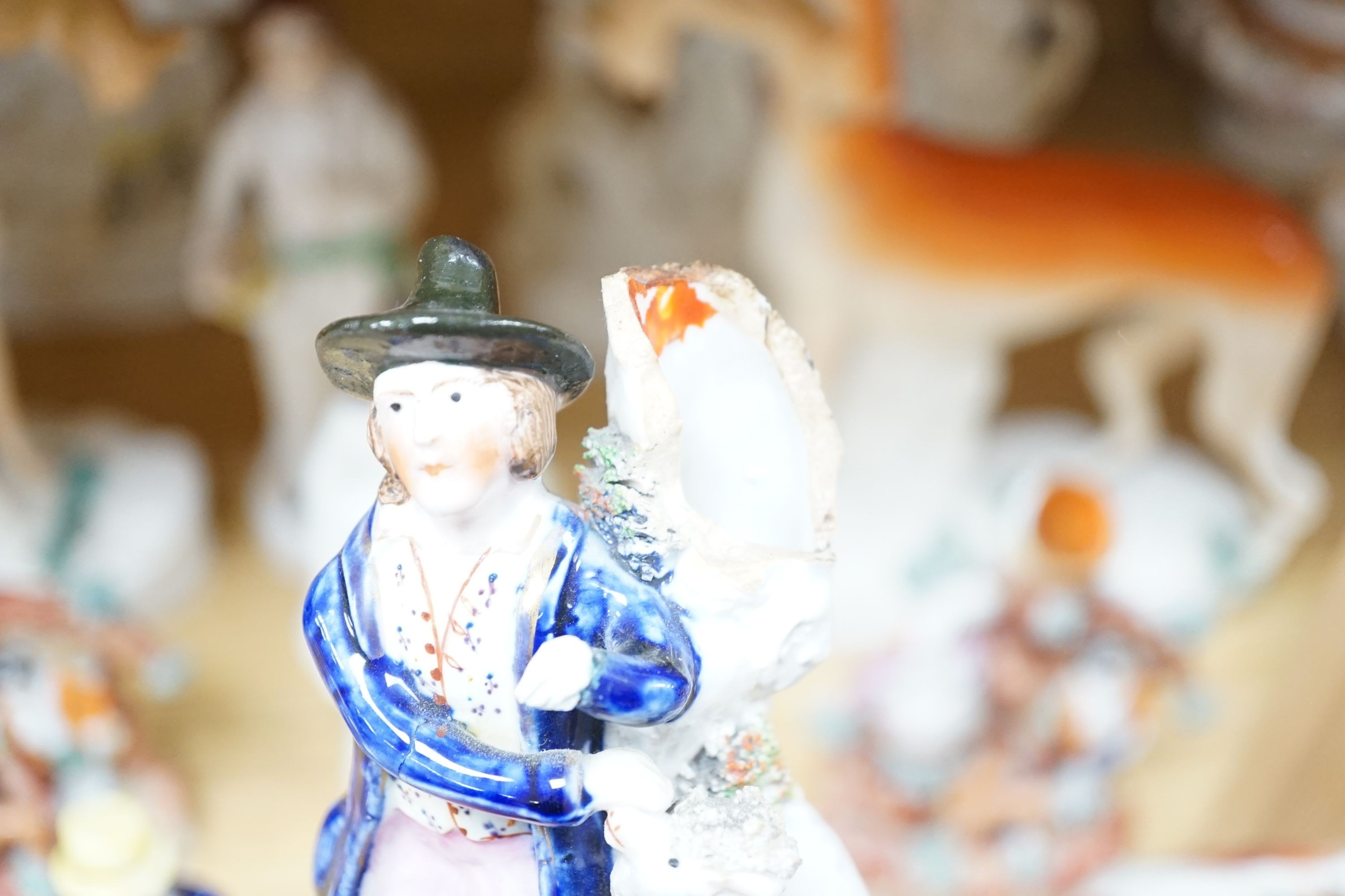 A collection of twelve Victorian Staffordshire flat back figures and groups, tallest 31 cms high.